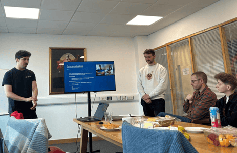 Two people presenting in a meeting room