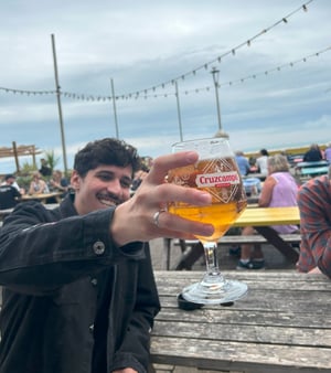 Point of view shot of a participant cheersing a beer