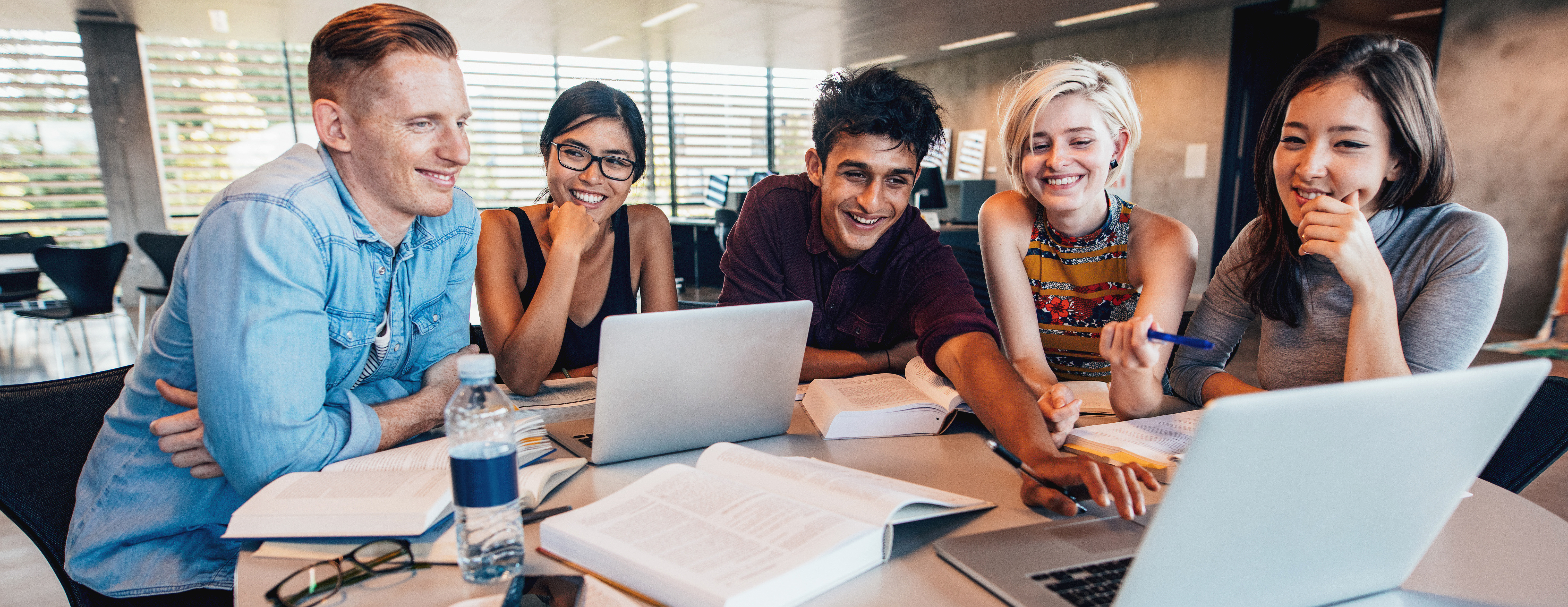 A group of young people working around a table